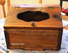 an old wooden box with a hole in it