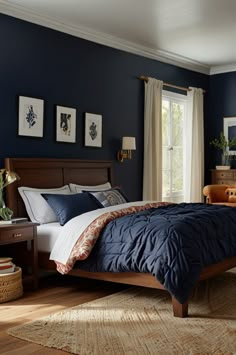 a bed room with a neatly made bed and blue walls