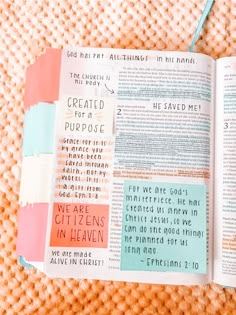 an open bible with colorful paper on it