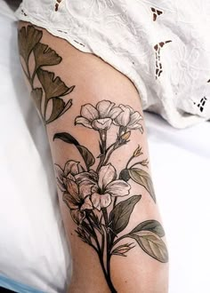 a woman's leg with flowers on it, and the words nature inspired net - traditional tattoos by sophia baughn neo