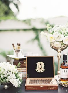 a table topped with bottles of liquor and flowers