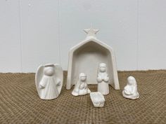 a nativity scene with three figurines and a star