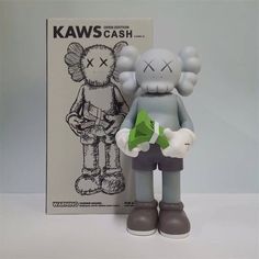 a gray and white figure next to a box with an image of a cartoon character on it