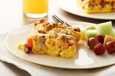 two plates with food on them, one has fruit and the other has a fork