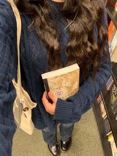 a woman holding a book in her hands