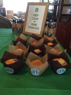 starbucks cupcakes are arranged on a table with a sign that says keep calm and drink starbucks