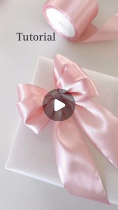 a pink ribbon on top of a white box with the words, how to make a satin ribbon