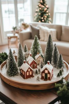 a tray with christmas trees and small houses on it