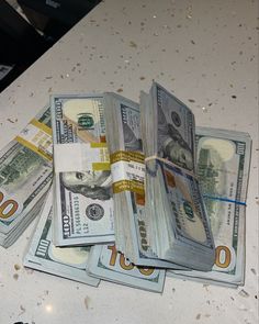 a bunch of money sitting on top of a counter