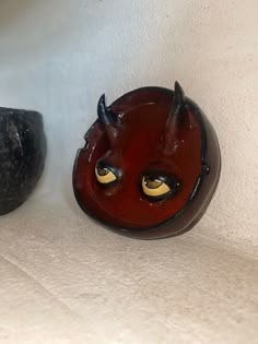 two red and black objects sitting on top of a white counter next to each other