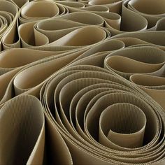 an array of rolled up brown paper on top of each other, with lines in the middle