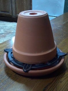 a brown object sitting on top of a wooden table