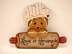 a ginger with a chef's hat is holding a sign that says love is homemade