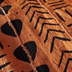 an orange and black pattern on fabric