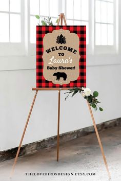 a welcome sign for a baby shower is displayed on an easel