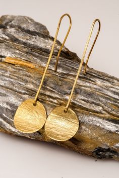 Round earrings golden perfect for gifts, thanks giving and Christmas and gift for her. You'll create an eye-catching look when you wear these Round Drop Earrings. These fashion earrings add shine to all your outfits. They feature a gold tone finish, drop design and round shape that you will love. These lightweight earrings come with classic hook closures for secure and comfortable wear, and they're made from high-quality copper material to suit most skin types. Wear them with a little black dres Matte Gold Plated Earrings As A Gift, Cadmium-free Yellow Gold Dangle Earrings, Gold Nickel-free Earrings For Gift, Gold Hammered Metal Hoop Earrings, Antique Gold Plated Earrings For Gift, Minimalist Recycled Gold Earrings In Gold, Gold Nickel-free Drop Earrings, Gold Round Earrings With Ear Wire, Handmade 14k Gold-filled Gold Earrings