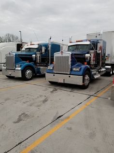 two semi trucks parked in a parking lot