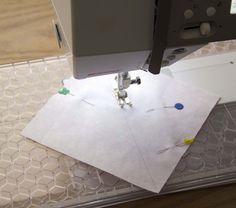 the sewing machine is working on some paper