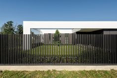 a black and white house with an iron fence