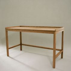 a wooden table sitting on top of a white floor