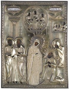 an ornate metal plaque depicting the virgin mary and jesus with other people in silver clothing