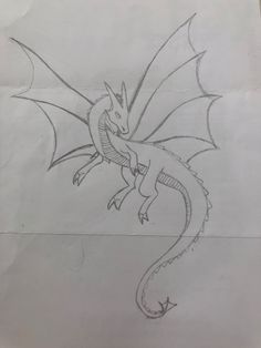 a drawing of a dragon on paper