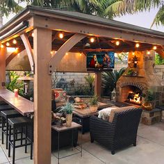 an outdoor living area with patio furniture and lights on the ceiling, covered in wood