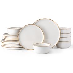 a stack of white and gold dinnerware on a white background with one empty plate in the middle