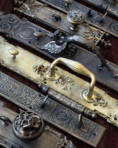 an assortment of antique brass door handles and knobs, all with intricate designs on them