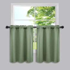 a window with green curtains in front of it