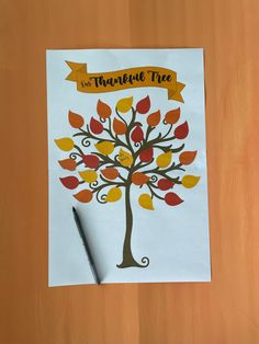 a paper with a tree on it next to a pen and some writing material that says, the thanksgiving tree