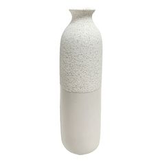 a white vase sitting on top of a table