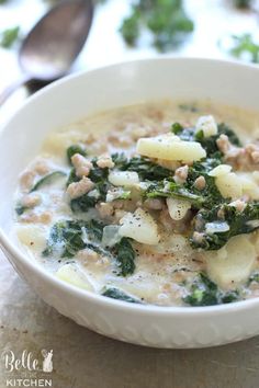 a white bowl filled with soup and vegetables