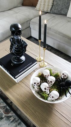 a coffee table with skulls and candles on it