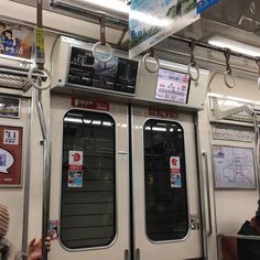 the inside of a subway car with two doors