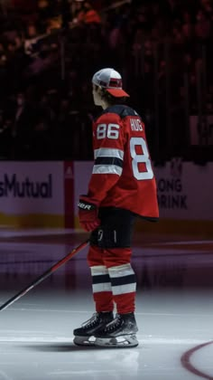 a hockey player is standing on the ice