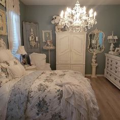 a bed room with a neatly made bed and a chandelier