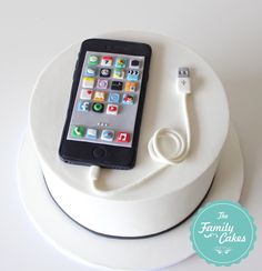 a cell phone sitting on top of a white cake