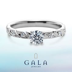 a white gold ring with a diamond in the center and leaves on it's side