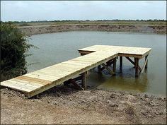 a wooden dock sitting in the middle of a body of water