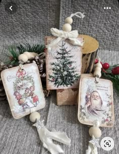 some ornaments are sitting on a couch near pine cones and other decorations, including an ornament