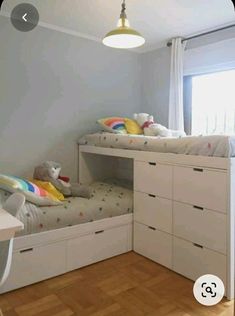 there are two bunk beds in the room with drawers on each side and one bed has a stuffed animal at the bottom