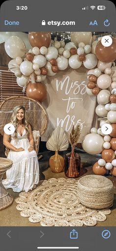 a woman sitting on a wicker chair in front of a backdrop that says miss to mrs