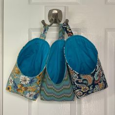 two purses hanging on a door handle