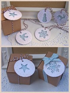 two boxes with tags on them and some paper snowflakes hanging from the top