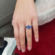 a close up of a person's hand with a ring on it