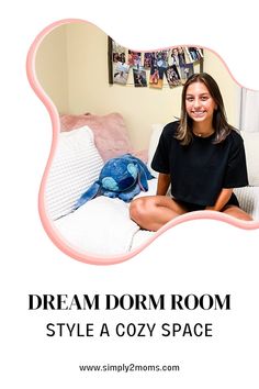 a woman sitting on top of a white couch next to a blue and pink stuffed animal