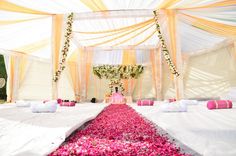 the aisle is decorated with pink flowers and white linens