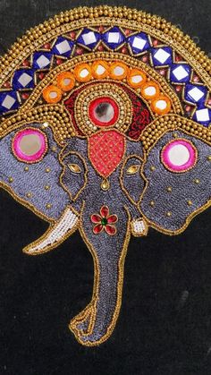 an elephant with colorful designs on it's face is shown in the middle of a black background