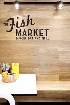 the fish market burger bar and grill is located in an upscale restaurant with wood paneling